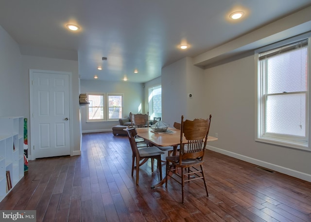 dining area featuring dark wood-type flooring