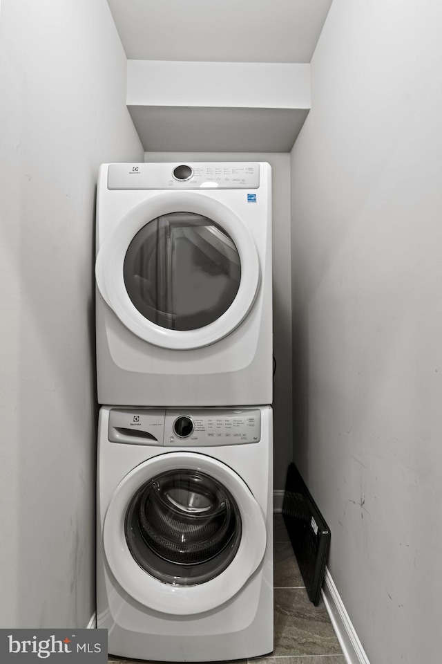 laundry area featuring stacked washer and clothes dryer