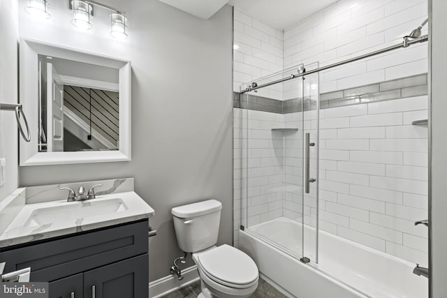 full bathroom with combined bath / shower with glass door, vanity, and toilet