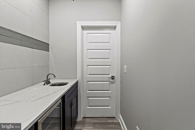 bathroom with vanity, hardwood / wood-style flooring, and beverage cooler