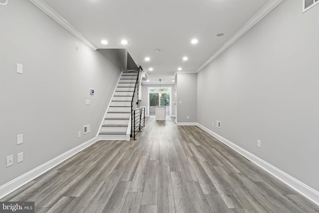 unfurnished living room with ornamental molding and light hardwood / wood-style flooring