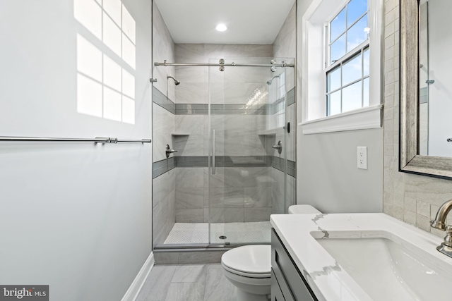 bathroom with vanity, toilet, and an enclosed shower