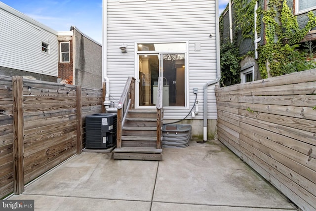 exterior space with central AC unit and a patio area