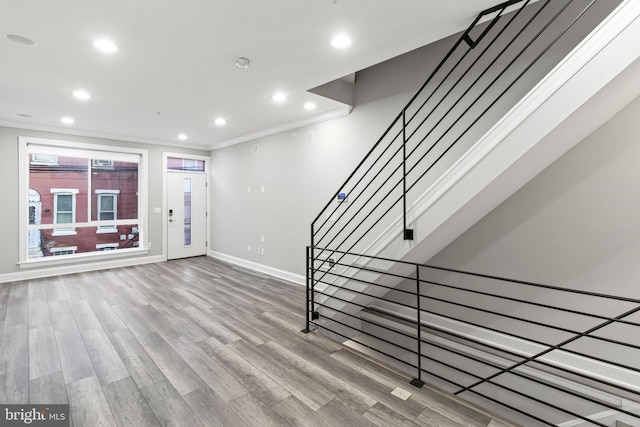 interior space featuring hardwood / wood-style flooring and crown molding