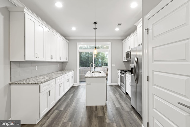 kitchen featuring white cabinets, appliances with stainless steel finishes, dark hardwood / wood-style floors, and a kitchen island with sink