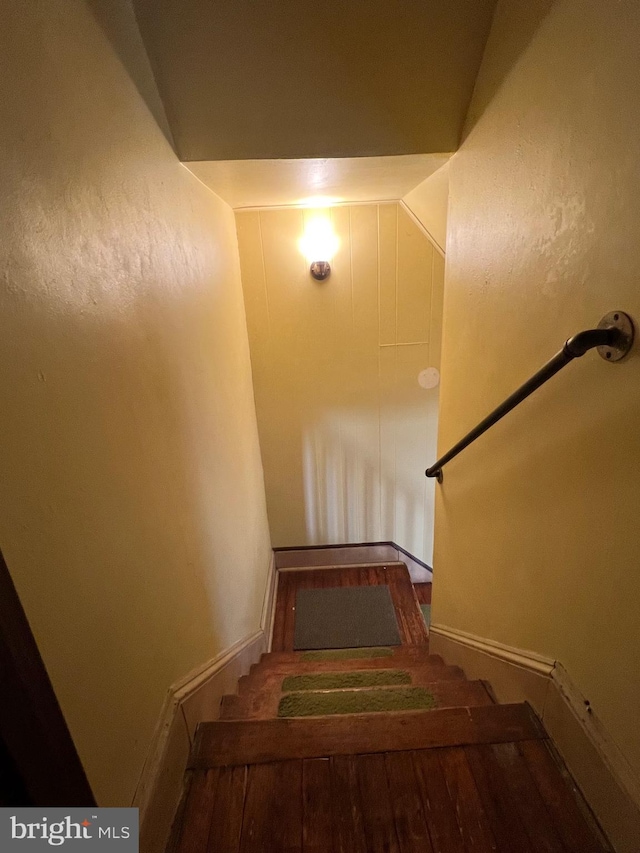 staircase featuring vaulted ceiling