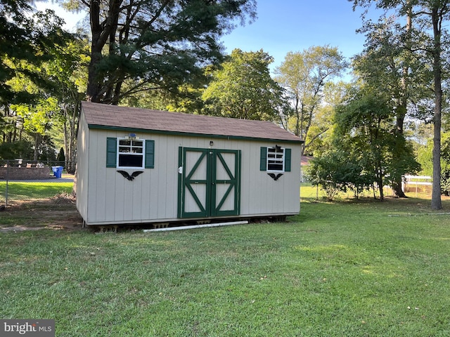 view of outbuilding featuring a yard