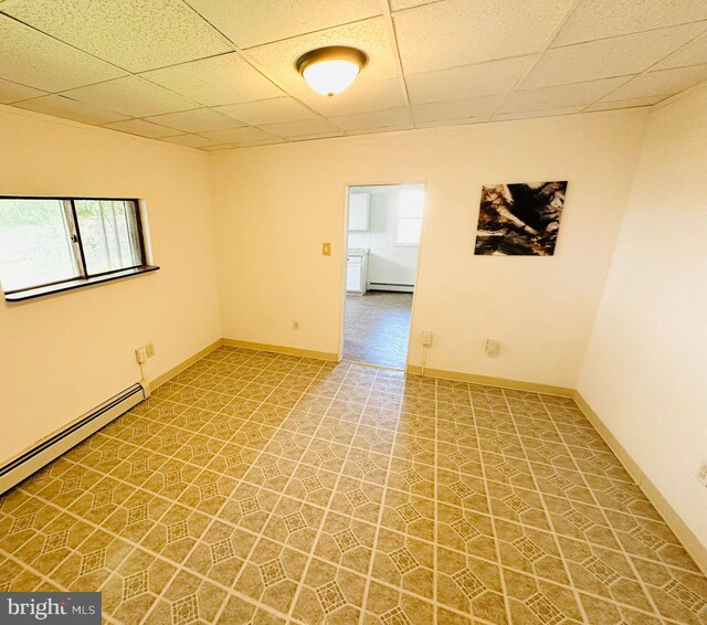 unfurnished room with a paneled ceiling