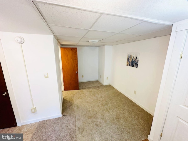 interior space with a drop ceiling and carpet floors