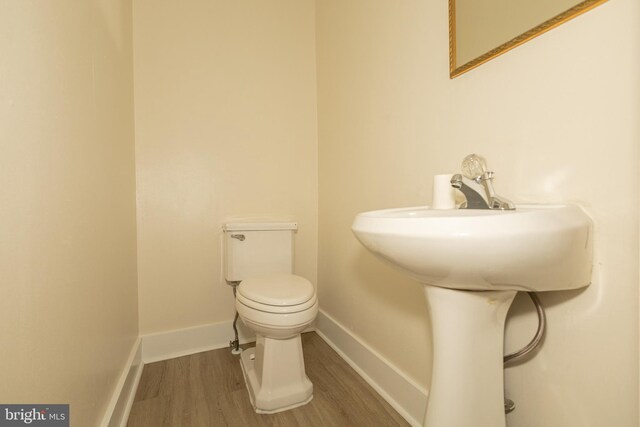 bathroom featuring toilet and hardwood / wood-style floors