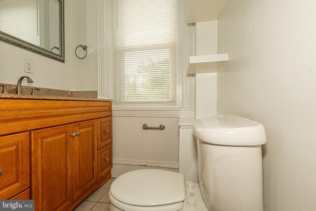 bathroom with vanity, toilet, and tile patterned floors