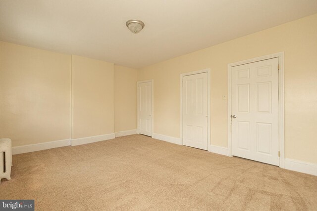 unfurnished bedroom with light colored carpet