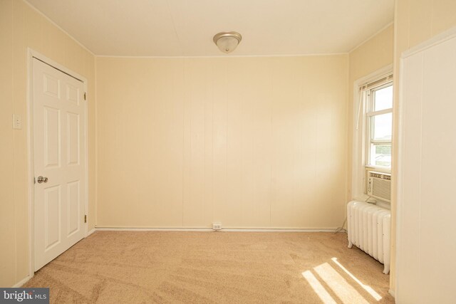 carpeted empty room with radiator