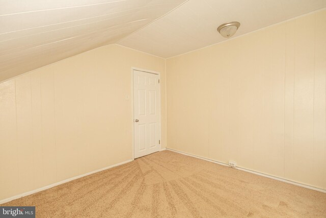 interior space featuring lofted ceiling and light colored carpet