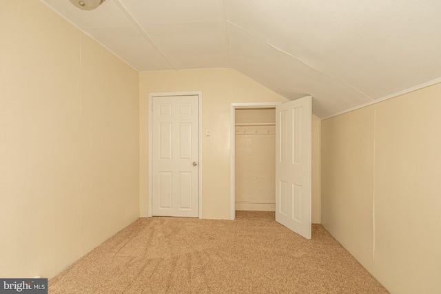 bonus room with lofted ceiling and light carpet