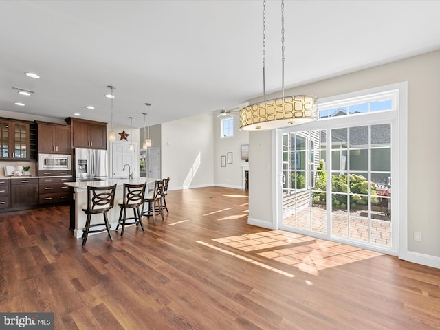 dining room with dark wood-type flooring, a wealth of natural light, and sink