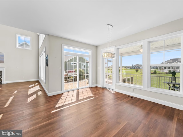 unfurnished dining area featuring dark wood-type flooring