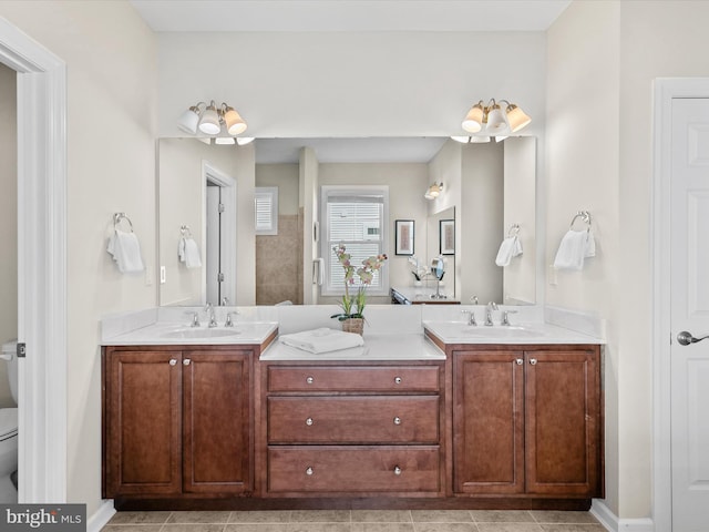 bathroom with vanity, toilet, and tile patterned floors