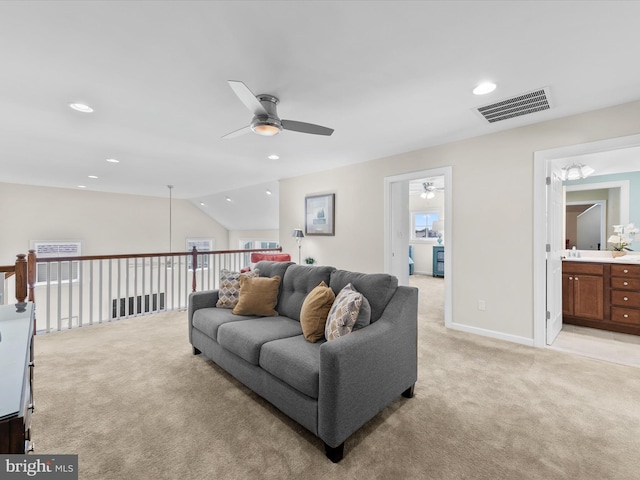 living room featuring ceiling fan, light carpet, and vaulted ceiling