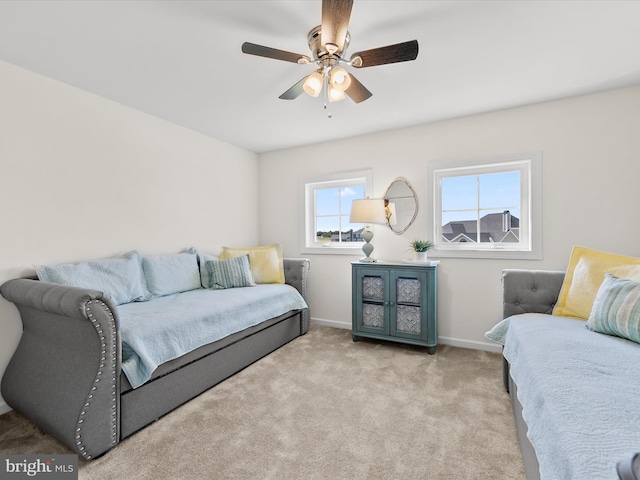 bedroom with ceiling fan and light carpet