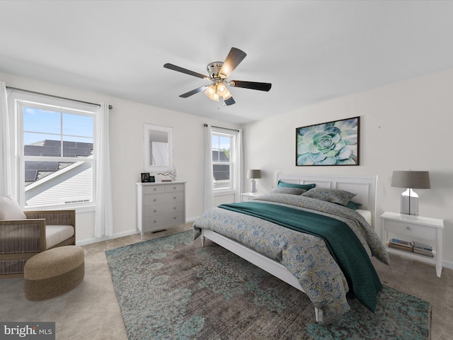 bedroom with ceiling fan and light carpet