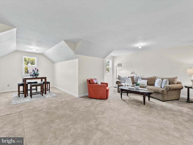 living room with light colored carpet and vaulted ceiling