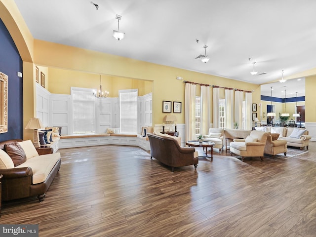 living room with hardwood / wood-style flooring, an inviting chandelier, and a healthy amount of sunlight