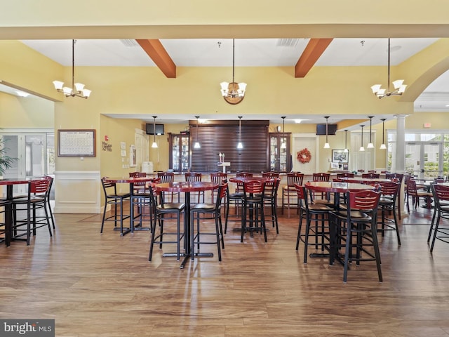 dining space with wood-type flooring and a chandelier