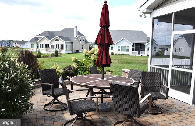 view of patio featuring a sunroom