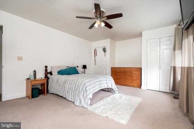 bedroom featuring light carpet and ceiling fan