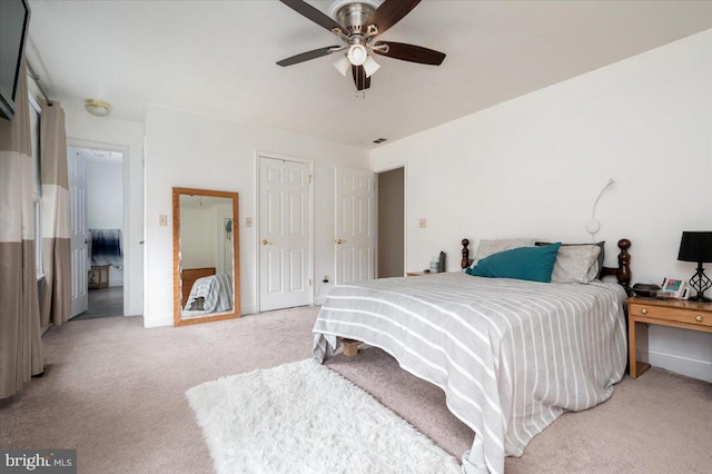 bedroom featuring light colored carpet and ceiling fan