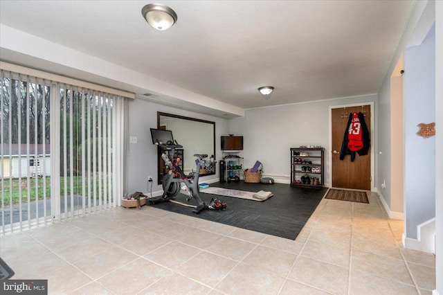 exercise area featuring light tile patterned floors