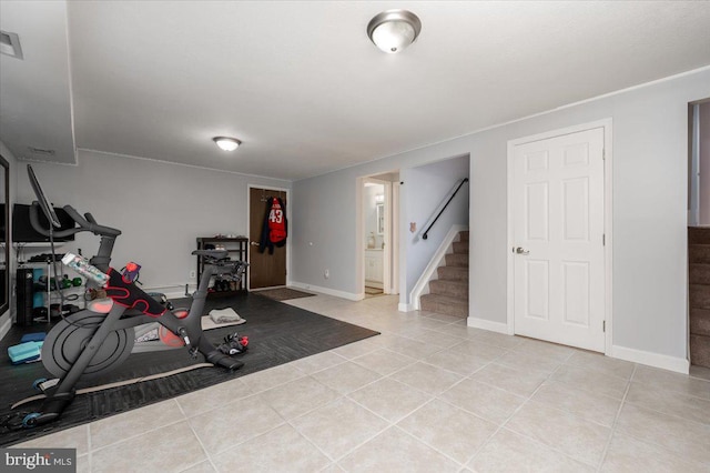 exercise area featuring light tile patterned flooring