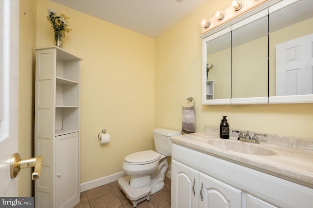 bathroom featuring vanity, tile patterned floors, and toilet