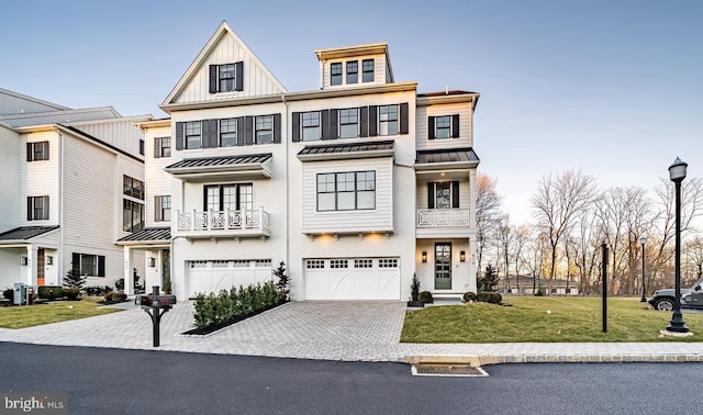 view of front of property with a garage and a front lawn