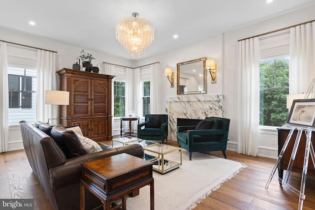 living room featuring hardwood / wood-style floors, plenty of natural light, and a notable chandelier