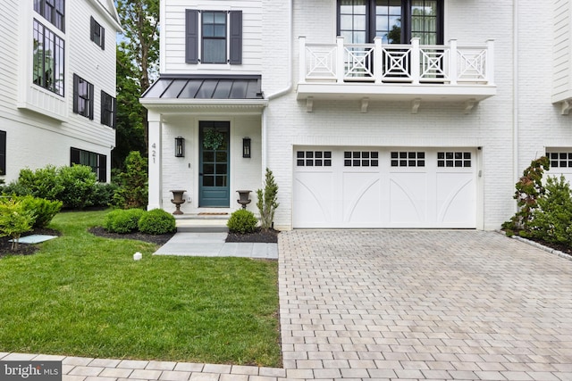 exterior space with a garage, a balcony, and a front yard