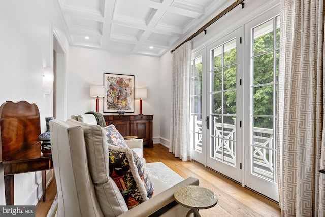 interior space with crown molding, light hardwood / wood-style flooring, coffered ceiling, and beamed ceiling