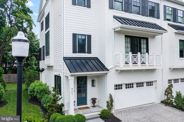 view of front of home with a balcony and a garage