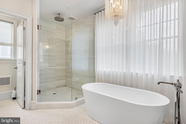 bathroom featuring separate shower and tub, a chandelier, and tile patterned flooring