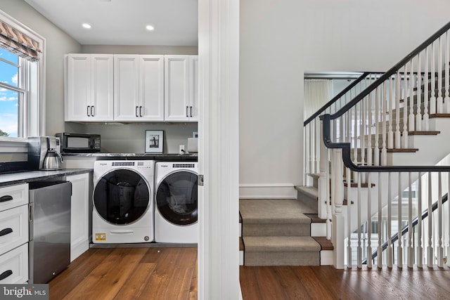 washroom featuring dark wood-type flooring and washer and clothes dryer