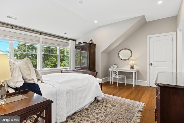 bedroom with vaulted ceiling and wood-type flooring