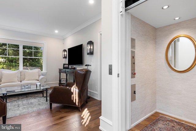 living room featuring dark hardwood / wood-style floors, crown molding, and elevator