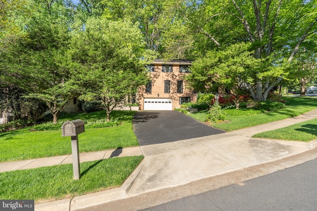 view of front of house featuring a garage and a front lawn