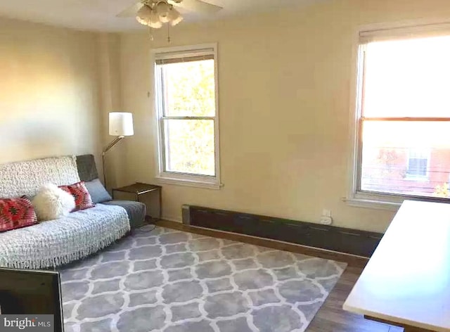 living area with ceiling fan and a healthy amount of sunlight