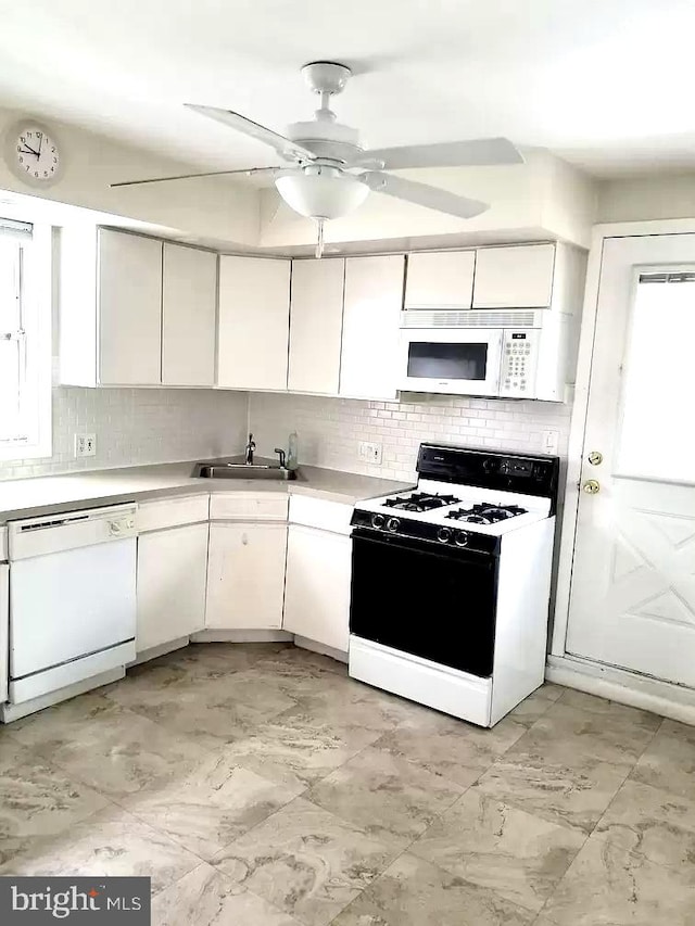 kitchen with white appliances, sink, ceiling fan, and decorative backsplash