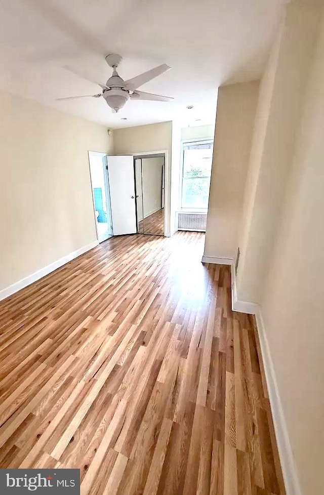 interior space with ceiling fan and light hardwood / wood-style floors