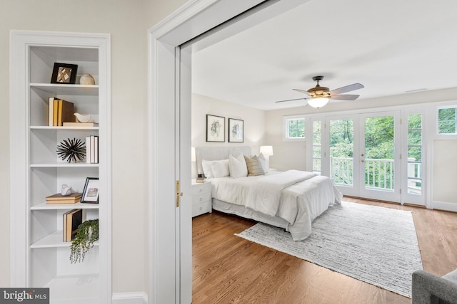 bedroom with ceiling fan, access to exterior, and light hardwood / wood-style flooring