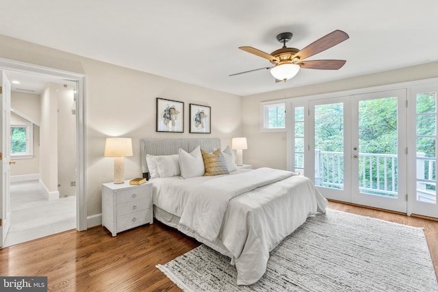 bedroom featuring french doors, hardwood / wood-style flooring, access to exterior, and ceiling fan