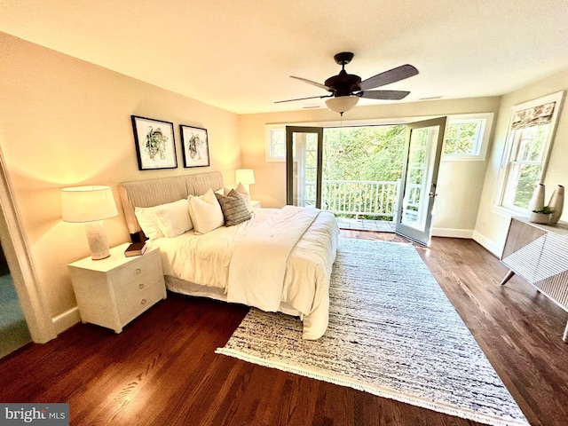 bedroom with baseboards, ceiling fan, dark wood-type flooring, and access to exterior